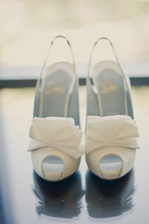 white Christian Louboutin shoes with bow.jpg